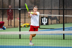 An IU Southeast Men's Tennis player returns a ball.